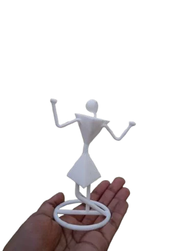 The white 3D printed key holder figure standing on a ring base, held in a hand